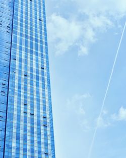 Low angle view of modern building against blue sky