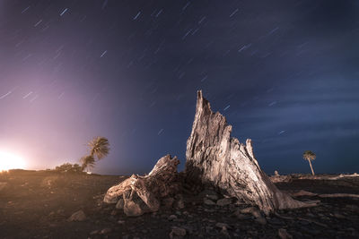 Rock formation against sky at night