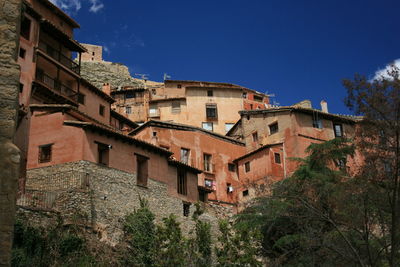 Low angle view of buildings against blue sky