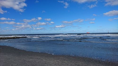 View of beach against cloudy sky