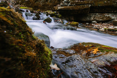Scenic view of stream flowing through rocks