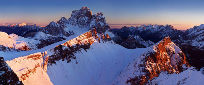 Scenic view of snowcapped mountains against sky during sunset