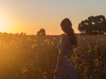 A young woman looking at the sunset