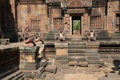 Statues on staircase outside building