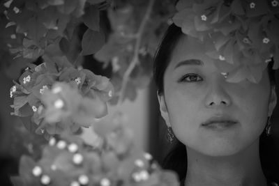 Close-up portrait of woman by plants