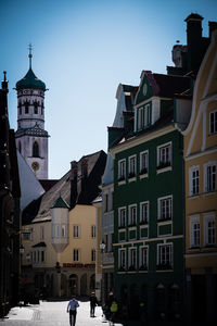 Street amidst buildings against clear sky