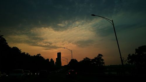 Traffic on road at sunset