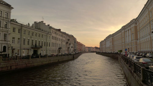 Canal amidst buildings against sky