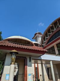 Low angle view of building against blue sky