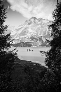 Scenic view of lake by mountains against sky