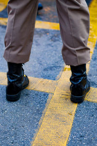 Low section of people walking on street