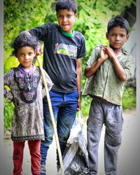 Portrait of siblings standing outdoors