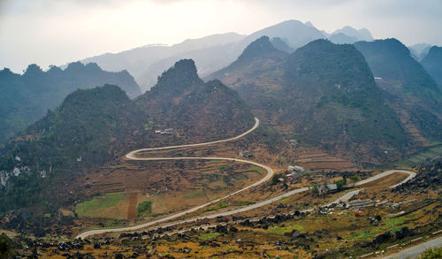 High angle view of road amidst mountains against sky