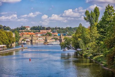 Arch bridge over river against sky