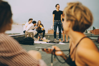 People sitting at market stall