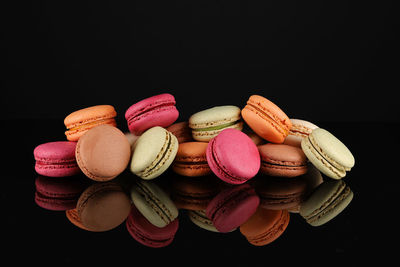 Close-up of macaroons against black background