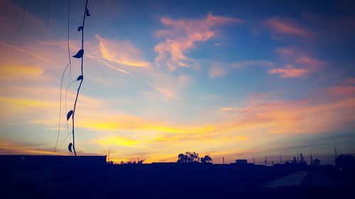 Silhouette buildings against sky during sunset