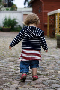 Rear view full length of girl on walkway