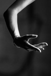 Close-up of human hand against black background