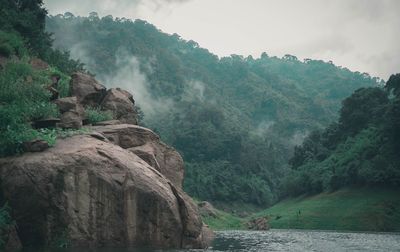 Scenic view of waterfall against sky