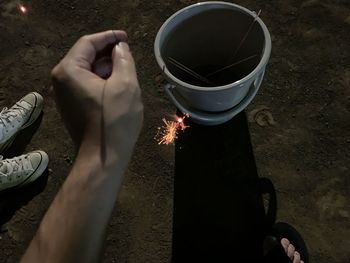 High angle view of man preparing food on fire