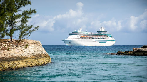 Ship sailing on sea against sky