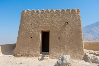 Exterior of old building against clear blue sky