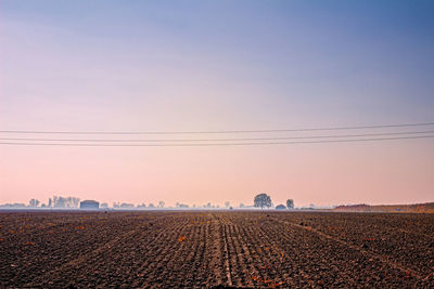 Scenic view of farm against clear sky