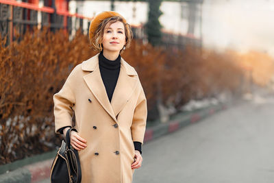 Portrait of young woman standing outdoors