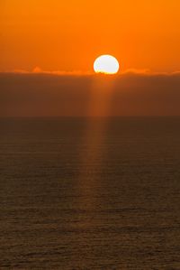 Scenic view of sea against orange sky