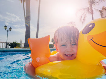 Portrait of boy swimming in pool