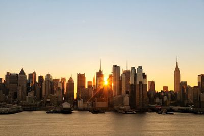 View of buildings in city at sunset