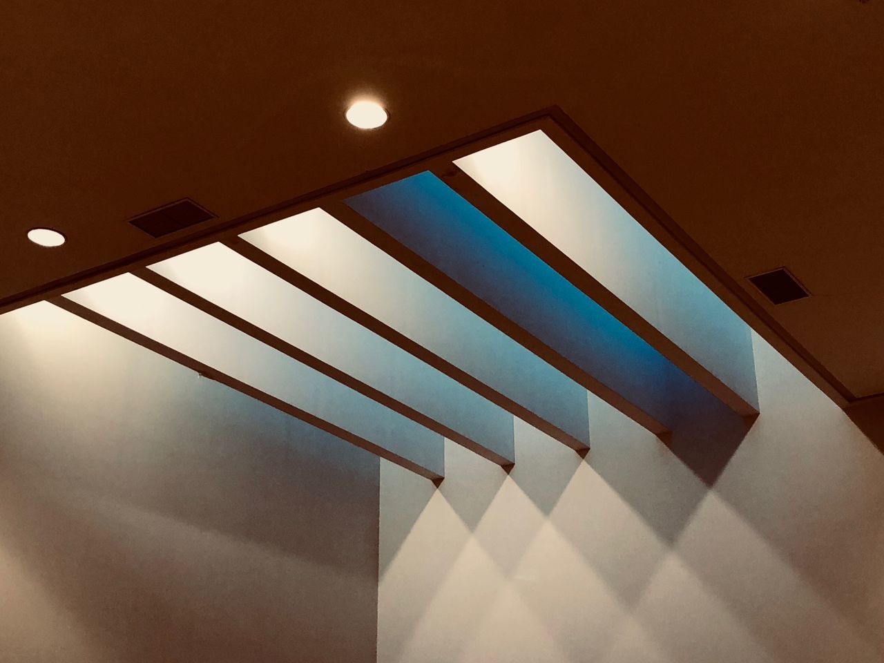 LOW ANGLE VIEW OF ILLUMINATED LAMP ON WALL