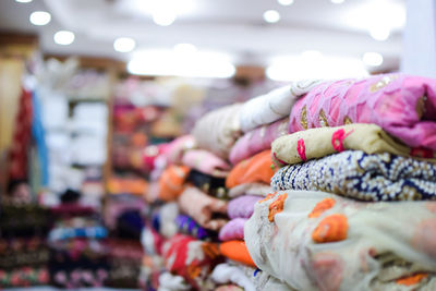 Close-up of stacked textiles for sale in store