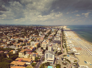 High angle view of townscape by sea against sky