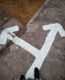 High angle view of arrow symbol on road