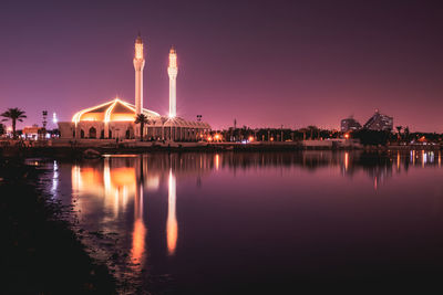 Reflection of illuminated buildings in lake at night