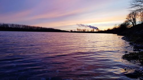Scenic view of lake against sky during winter