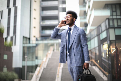 Full length of man using mobile phone