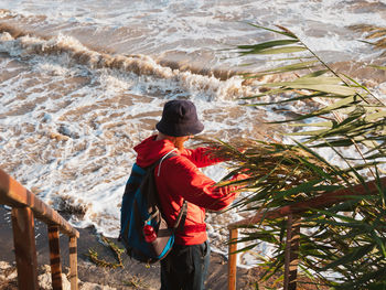 Rear view of man standing at beach