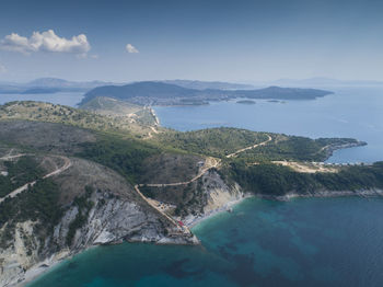 High angle view of sea and mountains against sky