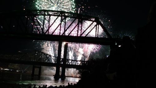 Low angle view of illuminated bridge at night