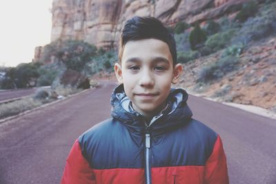 Portrait of boy standing on road