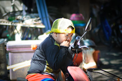 Rear view of boy holding umbrella