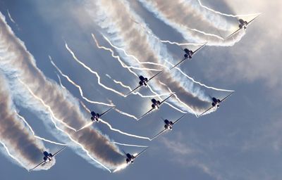 Low angle view of airplane flying against sky