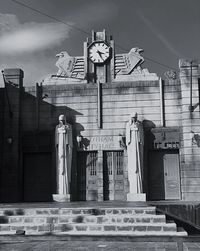 Low angle view of statues on building against sky