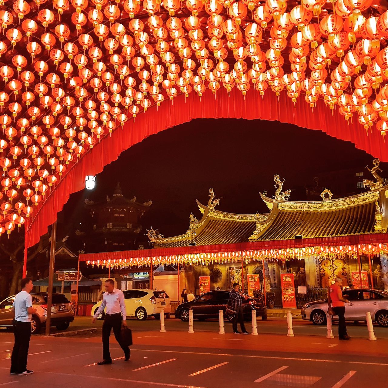 illuminated, architecture, built structure, lighting equipment, real people, group of people, red, decoration, men, lantern, art and craft, hanging, building exterior, crowd, night, chinese lantern, representation, festival