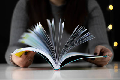 Midsection of woman reading book