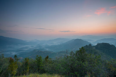 Scenic view of mountains against sky at sunset