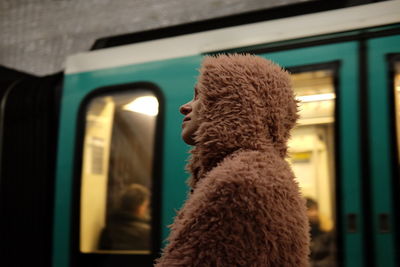 Low angle view of woman in fur coat at railroad station